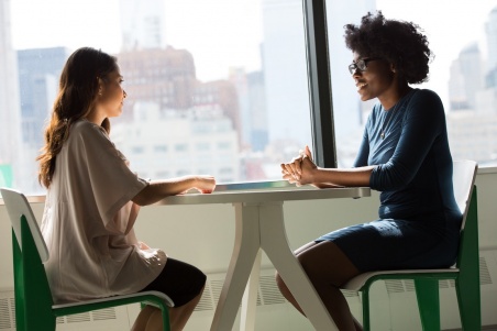 Two women preparing for MBA interviews