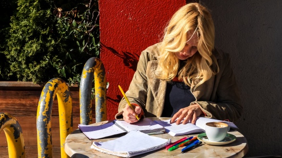 Woman reading at a cafe for the TOEFL.